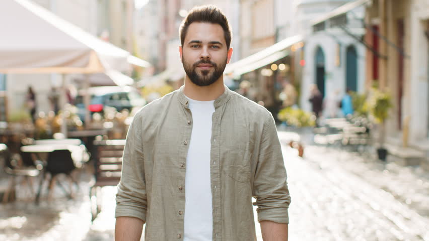 Like. Happy bearded young man looking approvingly at camera showing thumbs up, like sign positive something good positive feedback. Guy standing in urban city sunshine street. Town lifestyles outdoors | Shutterstock HD Video #1107485017