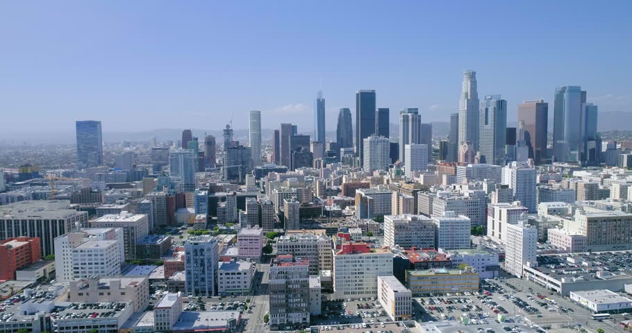 Aerial Forward Shot Of Apartments And Skyscrapers In City Against Sky During Sunny Day - Los Angeles, California