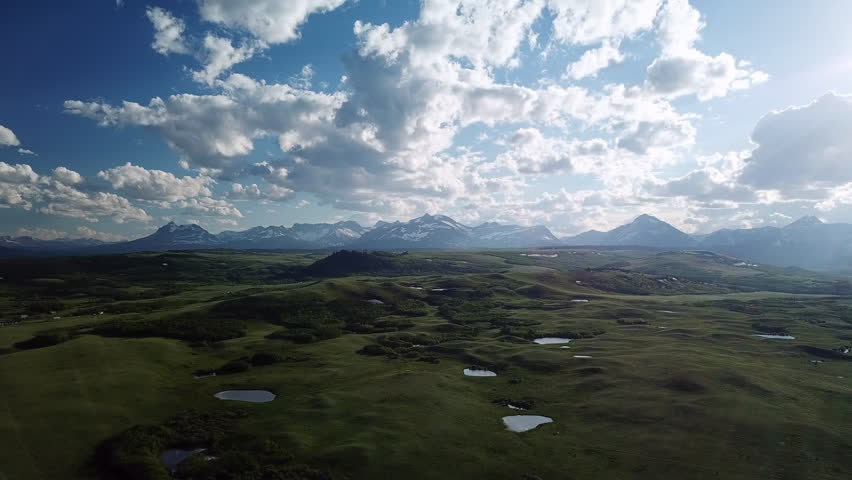 Aerial Shot Of Green Landscape With Plants Against Cloudy Sky, Drone Flying Near Mountain Ranges - Libby, Montana
