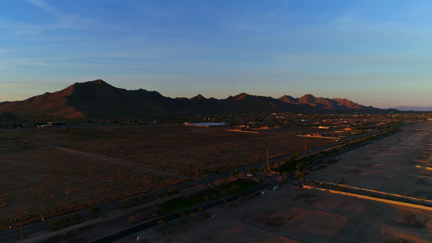 Aerial Forward Shot Of Industries By Mountain Against Sky During Sunset - Phoenix, Arizona
