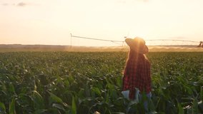 farmer irrigation woman in corn. agriculture irrigation corn business concept. farmer girl with a laptop walks through a green field of wheat. woman working in a field lifestyle with corn - Powered by Shutterstock - Get 15% off with code: PIKWIZARD15