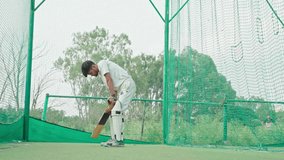 Cricket player facing or hits the ball in net practice time. - Powered by Shutterstock - Get 15% off with code: PIKWIZARD15