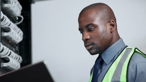 Cyber security, laptop and black man in server room, maintenance or database cables check, software update or network inspection. Technician, programmer or employee service backup hardware or repairs - Powered by Shutterstock - Get 15% off with code: PIKWIZARD15