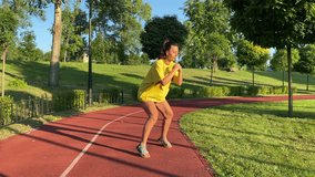 Active multiracial young woman engages in revitalizing morning exercising in golden sunlight of new day. She warms up stretching, doing invigorating workout in public park at daybreak. 360 degree shot