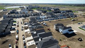 Aerial video of Brighton neighborhood in Saskatoon, SK, Canada. Captures the scenic urban layout, houses, and streets from a bird's-eye view. Ideal for urban planning and tourism.