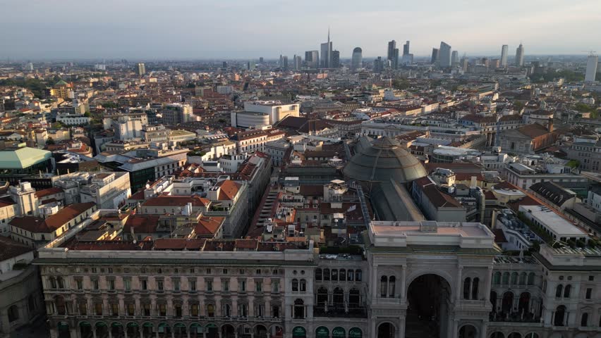 Europe, Italy , Milan - Drone aerial view of Piazza Duomo in city downtown - contrast between Vittorio Emanuele Gallery and the new modern skyline with skyscrapers in Garibaldi 