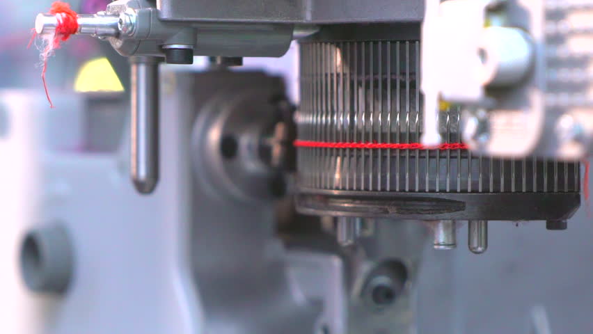 Circular loom. Industrial knitting machine. Knits with red thread. Royalty-Free Stock Footage #1107516109