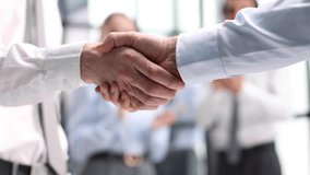 composite of Business people shaking hands against blurred background - Powered by Shutterstock - Get 15% off with code: PIKWIZARD15