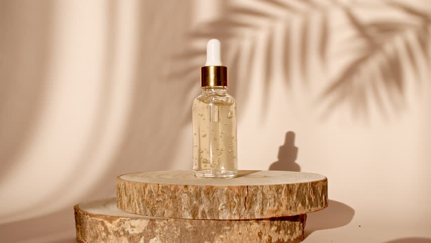 Podium for Presentation of a Cosmetic Product on Pastel Beige Background in the Morning Rays of Light and Shadows. Bottle with Pipette with Gel, Serum, Essential oil. Stage Pedestal or Platform. 4k
