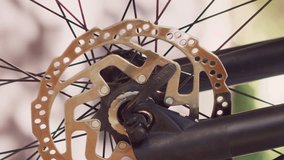 Vertical video Detailed view of caucasian person detaching tire from bike front fork for annual maintenance. Healthy man dismantling damaged bicycle wheel to repair with expert work tool for cycling