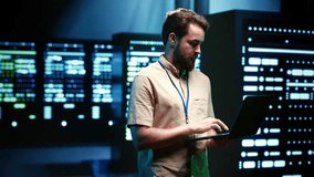 Precise serviceman verifying functional blade servers in computer network security data center. High tech facility infrastructure providing processing and memory resources for numerous workloads - Powered by Shutterstock - Get 15% off with code: PIKWIZARD15