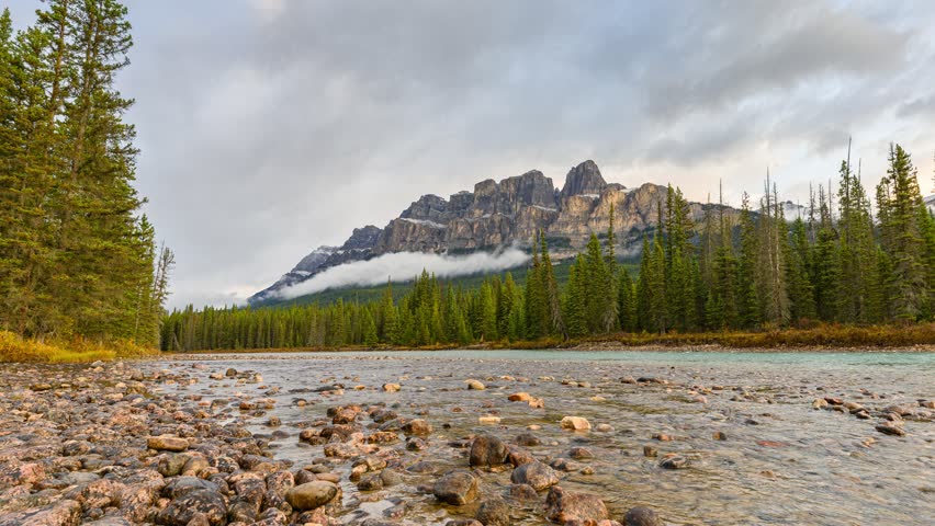 Time lapse of Scenery of sunrise over Castle mountain and bow river flowing in the morning at Banff national park, Alberta, Canada