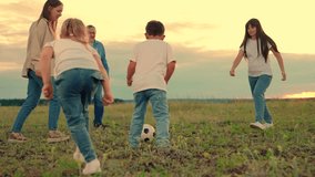 Happy family playing football. Child kicks ball. Family have fun playing soccer ball on lawn in park. Young family sport soccer team playing outdoors. Mom dad child play together, teamwork. Weekend - Powered by Shutterstock - Get 15% off with code: PIKWIZARD15
