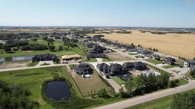 Aerial video of Greenbryre, Saskatoon, showcasing its luxury homes, expansive golf course, and lush landscapes. An elite community epitomizing upscale living. Ideal for high-end real estate visuals.