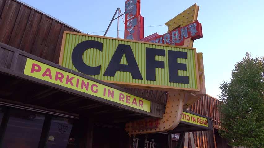Tehachapi, ca - 2023 - low angle view of a western-style retro cafe sign from its left side in tehachapi, california. Royalty-Free Stock Footage #1107531497
