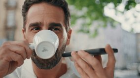 Successful executive sending audio use mobile phone virtual assistant at greenery city closeup. Latin man recording voice message drinking coffee at cafe. Manager consult client. Modern digital life  - Powered by Shutterstock - Get 15% off with code: PIKWIZARD15