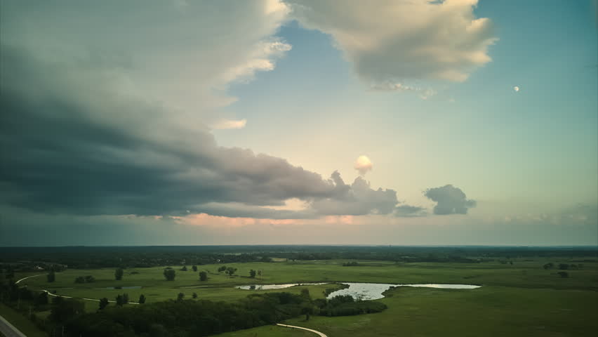 Time laps of clouds forming on gloomy sky before heavy rainfall over suburban town area. 
