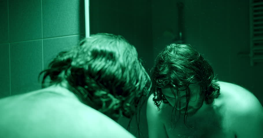 Stressed, depressed man looking at the mirror bathroom. Person in crisis concept. Strong emotional distress. Washing face with cold water. Mental health, man depression. Depressive light | Shutterstock HD Video #1107537745