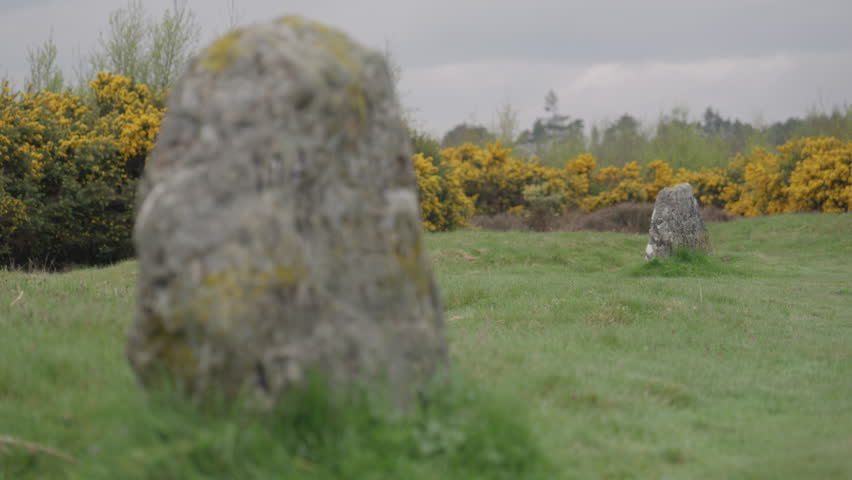 Pull focus transition between two memorial headstones on the famous Culloden battlefield, Scotland