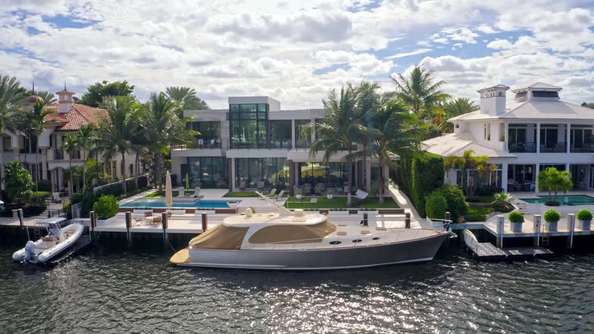 Aerial drone 4k ultra hd Shoot Footage in Fort Lauderdale, Florida, USA, commercial area, luxury houses, buildings and mansions, abundant tropical vegetation around, blue sky and Ocean.