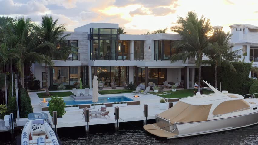 Aerial drone 4k ultra hd Shoot Footage in Fort Lauderdale, Florida, USA, commercial area, luxury houses, buildings and mansions, abundant tropical vegetation around, blue sky and Ocean.