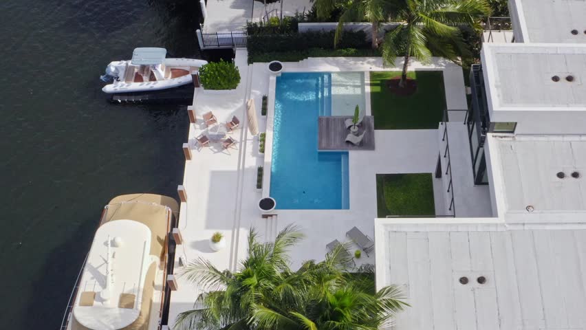 Aerial drone 4k ultra hd Shoot Footage in Fort Lauderdale, Florida, USA, commercial area, luxury houses, buildings and mansions, abundant tropical vegetation around, blue sky and Ocean.