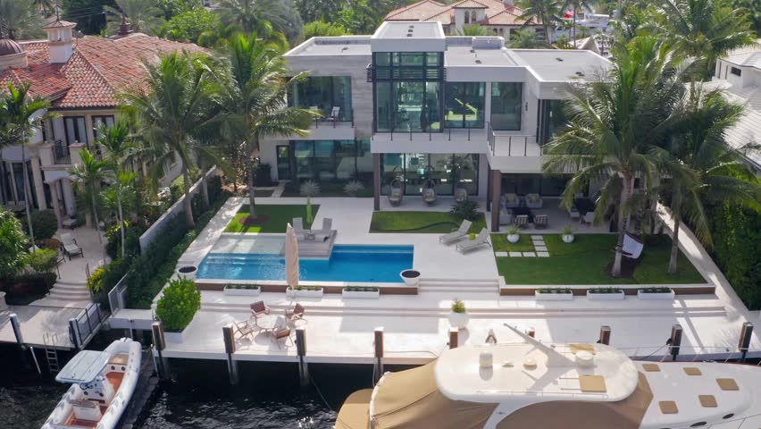 Aerial drone 4k ultra hd Shoot Footage in Fort Lauderdale, Florida, USA, commercial area, luxury houses, buildings and mansions, abundant tropical vegetation around, blue sky and Ocean.