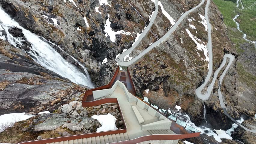 Viewing platform over Stigfossen Waterfall, Trollstigen Road, Norway. Aerial parallax. Royalty-Free Stock Footage #1107548775