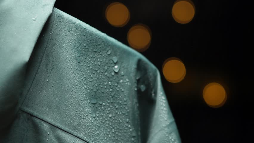 4K shot of water splashing on waterproof mint color cloth. Drops of water fall and roll down the waterproof fabric membrane jacket not pass moisture. Slow motion macro close-up. Royalty-Free Stock Footage #1107549249