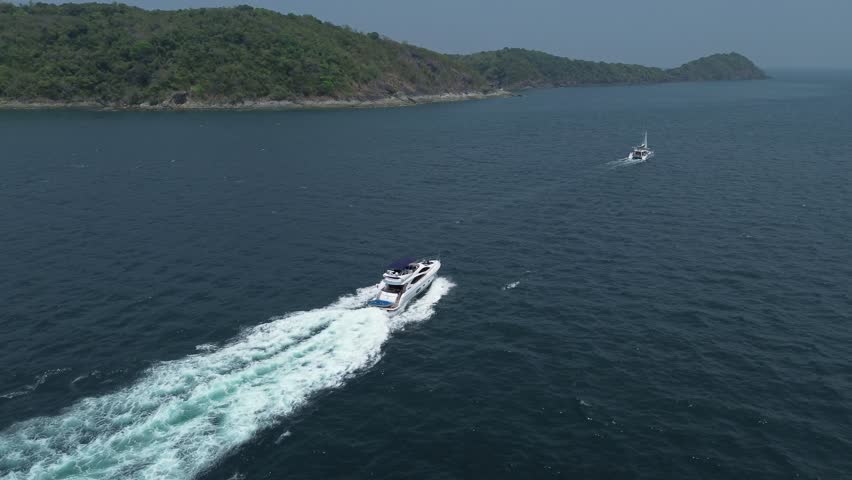 Motor private yacht in motion on the sea, high altitude view of a private motor yacht in a tropical sea Royalty-Free Stock Footage #1107554205