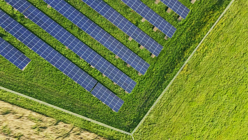 Top down aerial of rows of photovoltaic solar panels on a sunny day