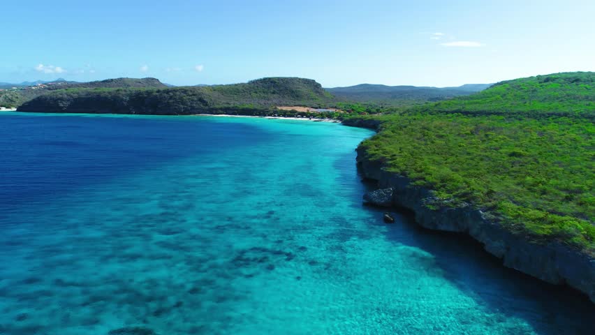 Panoramic aerial view of curacao green coastline with deep blue turquoise ocean waters