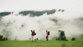 Group of young friends hiking in countryside. Three men walking by hiking trail. Three Friends Travel and Adventure Concept in Bedni bugyal, Uttarakand, India.
