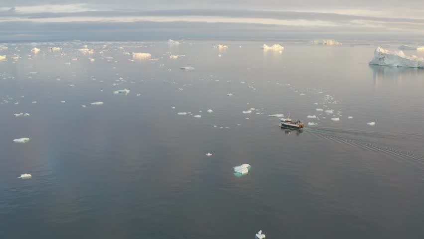 A small boat among icebergs in Greenland
Tourists take pictures of the iceberg. Source of icebergs is by the Jakobshavn glacier. The phenomenon of global warming and catastrophic thawing of ice, Disko