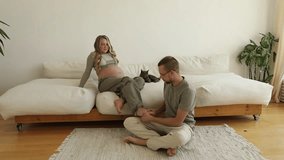 A man massages feet of a pregnant woman in a bright apartment - Powered by Shutterstock - Get 15% off with code: PIKWIZARD15