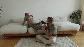 A man massages feet of a pregnant woman in a bright apartment - Powered by Shutterstock - Get 15% off with code: PIKWIZARD15