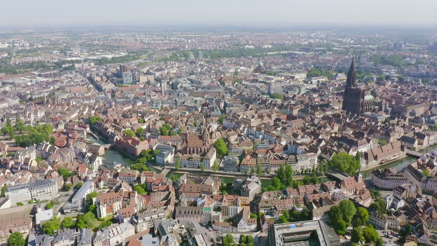 Inscription on video. Strasbourg, France. The historical part of the city, Strasbourg Cathedral. Multicolored text appears and disappears, Aerial View, Point of interest