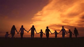 community big family walk in park. a big group of people holding hands walking silhouette on nature sunset in the park. big family kid dream concept. people in the park lifestyle. large family - Powered by Shutterstock - Get 15% off with code: PIKWIZARD15