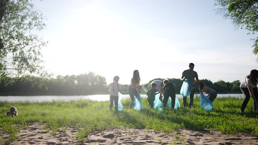 group of volunteers clean up trash. environmental protection ecology cleaning from garbage plastic concept. group world people volunteers collects plastic bottles garbage in bags silhouette Royalty-Free Stock Footage #1107572999