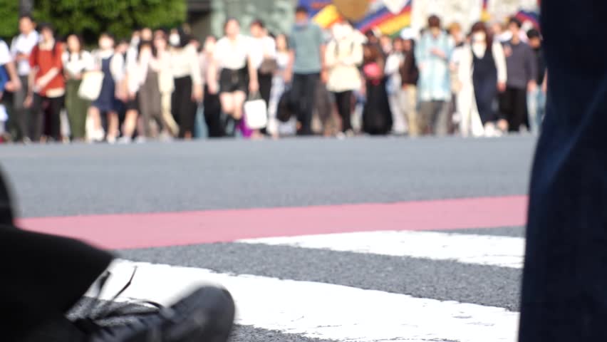 SHIBUYA, TOKYO, JAPAN : Crowd of people walking at Shibuya crossing in daytime. Busy downtown area in Tokyo. Japanese people, lifestyle, urban city life and travel concept video. Slow motion shot.
