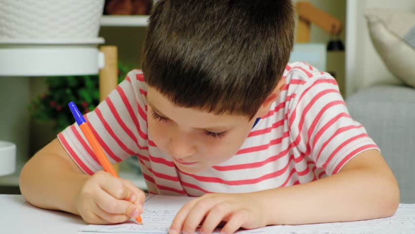 A six-year-old boy learns to write, hand and write close-up Royalty-Free Stock Footage #1107577243