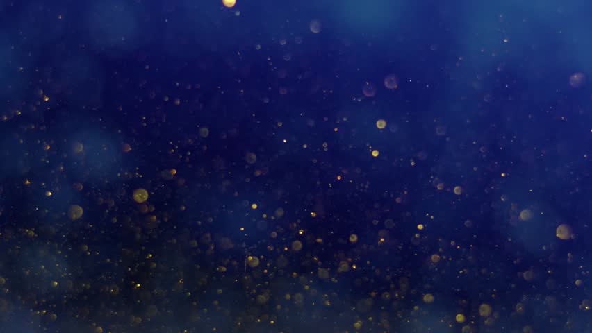 Particles of gold color fall on a dark blue background in an abstract order, beautiful reflection of glare from the light, bokeh and out of focus glare. Slow motion, 8K downscale, 4K. Royalty-Free Stock Footage #1107580023