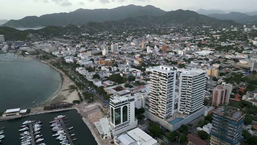 aerial Santa Marta City Marina, Colombia, Aerial View of Sailboats, Breakwater and Cityscape Skyline Sierra Nevada mountain and luxury hotel in the rodadero