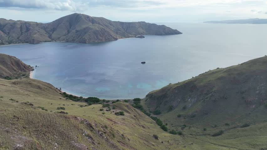 A scenic bay on the island of Komodo is fringed by healthy coral reef. This is a popular island to visit as it is home to Komodo dragons as  well as extraordinary marine biodiversity.