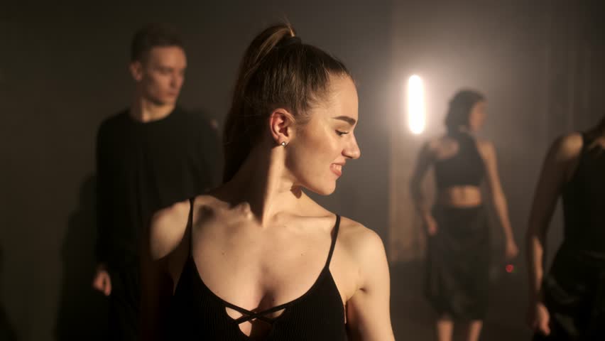 A group of dancers are rehearsing a dance on stage. The concept of modern dance.