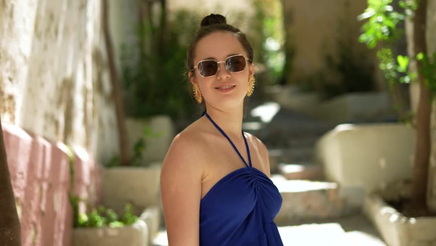 Girl in sunglasses exploring Ibiza old town streets and alleys