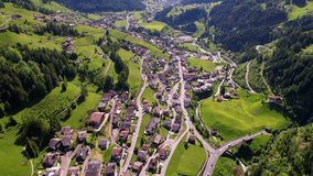 Breathtaking vew of beautiful Alps mountains Dolomites, and Val Gardena village ski resort in south Tyrol in northern Italy. Alpine nature scenery. aerial drone video 