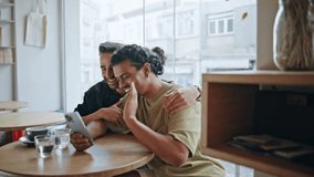 Homosexual family video calling sitting small restaurant at romantic date close up. Happy multiracial gay partners greeting to phone camera. Smiling men lovers enjoy online communication in cafeteria. - Powered by Shutterstock - Get 15% off with code: PIKWIZARD15