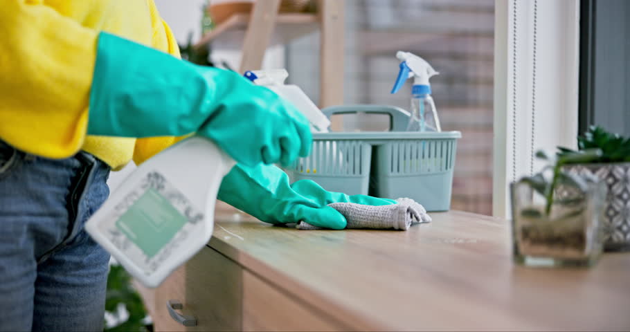 Cleaner, hands and person with spray, cleaning furniture and chemical with hygiene and gloves, disinfection and product. Hospitality, housekeeping and service with janitor, house work and detergent Royalty-Free Stock Footage #1107612267