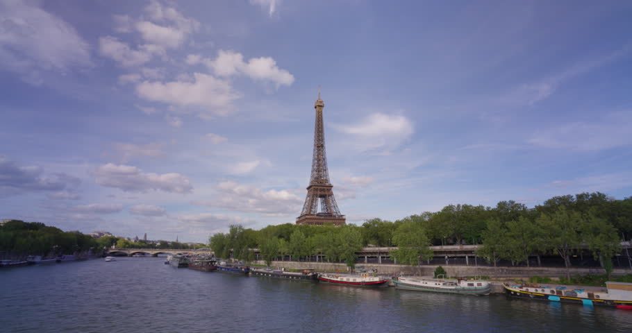 Time lapse. Romantic cozy view of the famous Eiffel tower from a small Paris street wide horizontal panorama. Camera fixed position Royalty-Free Stock Footage #1107613525